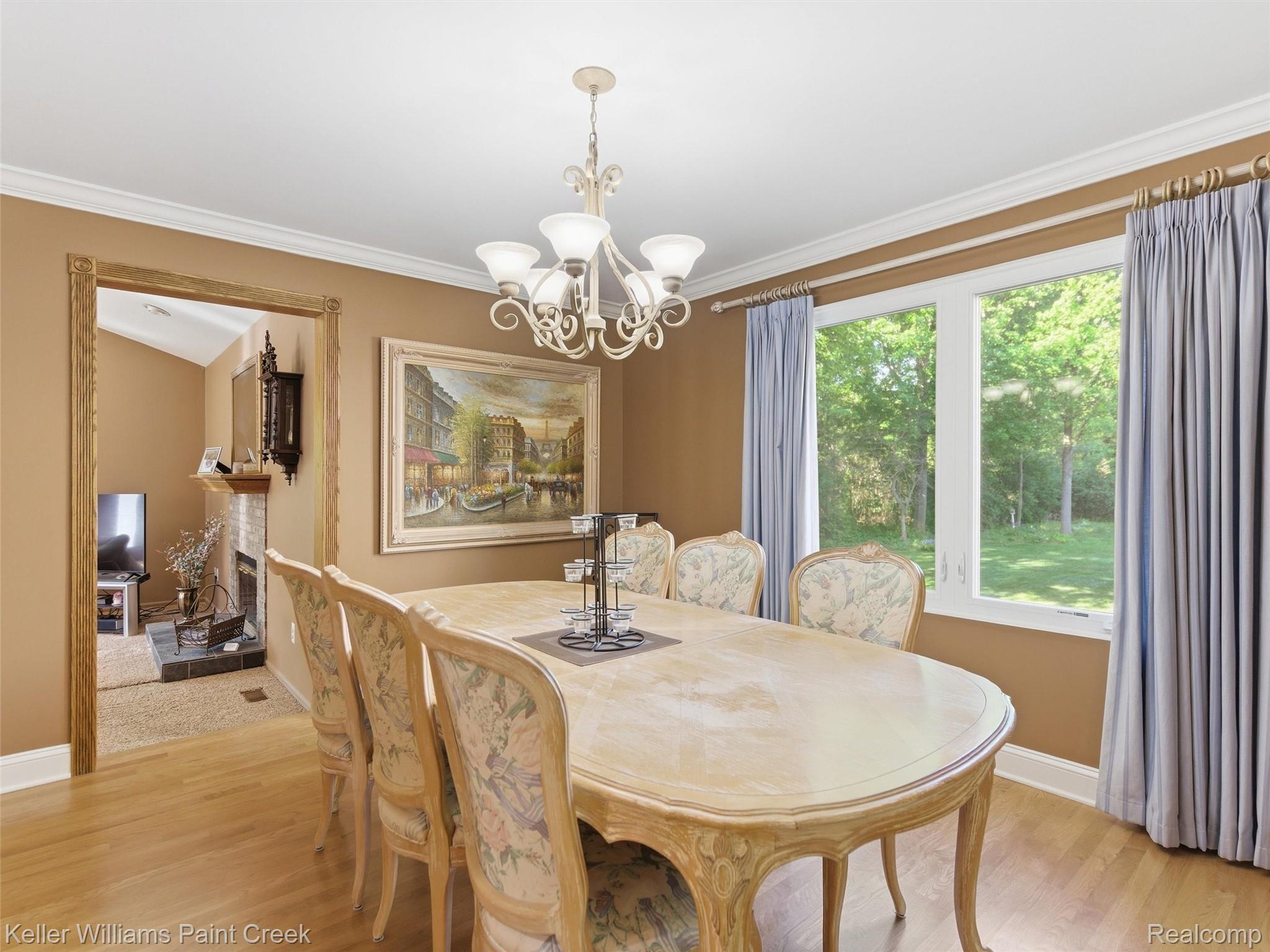 2842 Manorwood Road Troy, MI 48085 - Photo 25 of 72 Dining area featuring light wood-finish flooring, a decorative chandelier, and crown molding