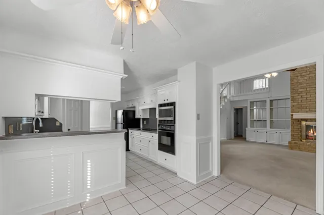 a kitchen with stainless steel appliances a sink a stove a refrigerator and cabinets