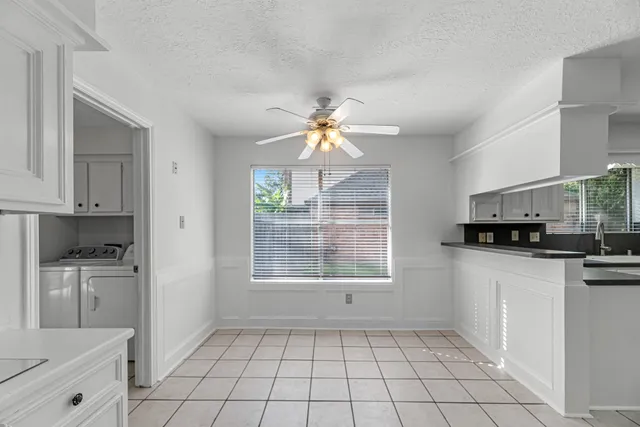 a kitchen with stainless steel appliances a sink a stove a microwave a sink a refrigerator and cabinets