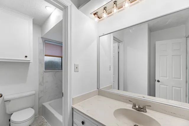 a bathroom with a toilet and bathtub