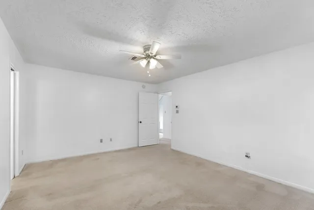a white toilet sitting next to a bathroom sink and vanity
