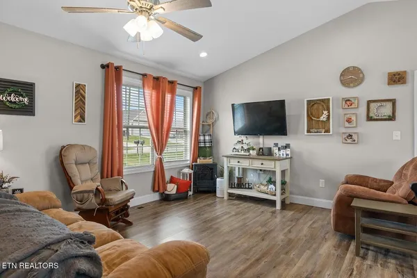 a living room with furniture and a flat screen tv
