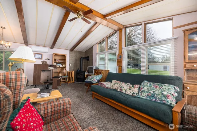 a living room with furniture and a floor to ceiling window