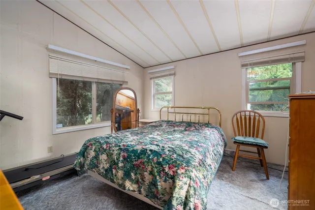 a bed sitting in a bedroom next to a window