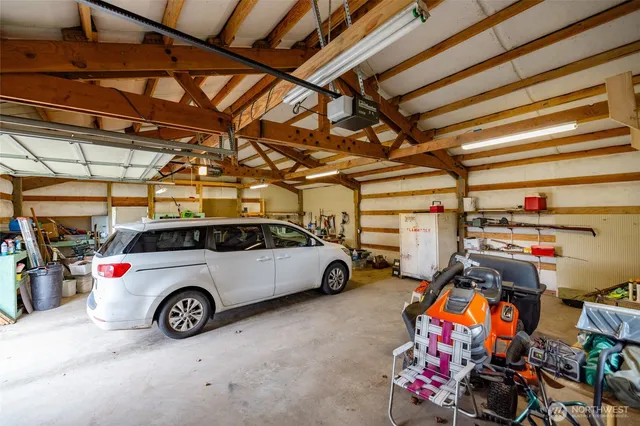 a view of parking garage with cars and other equipment