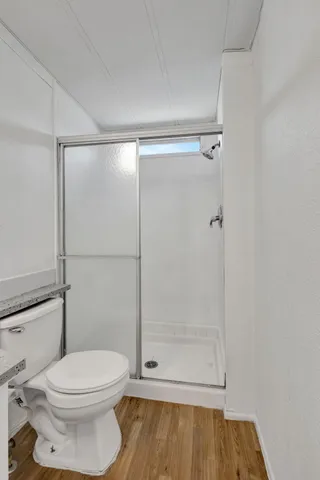 a bathroom with a toilet and a shower