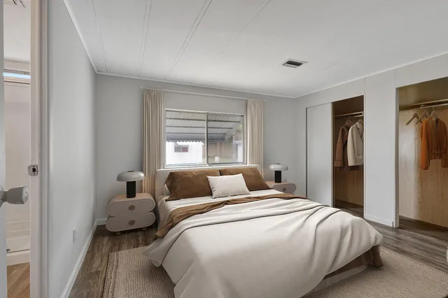 a bedroom with a bed and a window