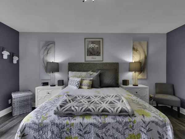a bedroom with double bed and a lamp