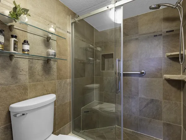 a bathroom with a shower and a toilet