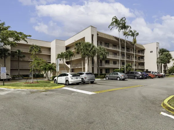 a view of a house with a patio and a yard