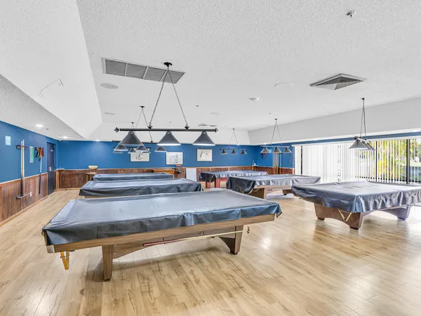 a living room with chairs and a table
