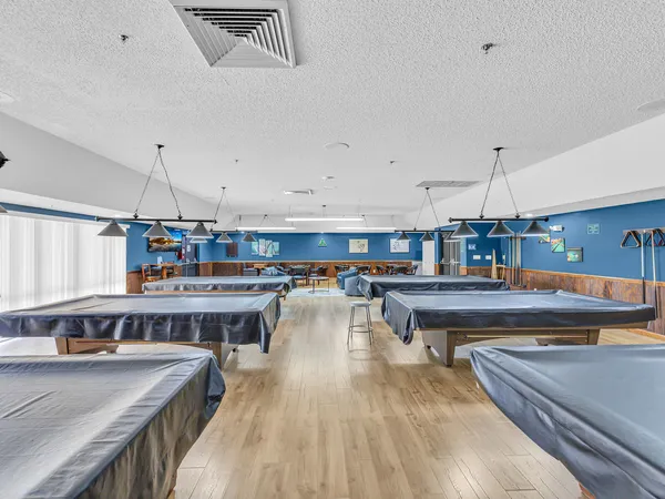 a living room with lots of furniture and kitchen view