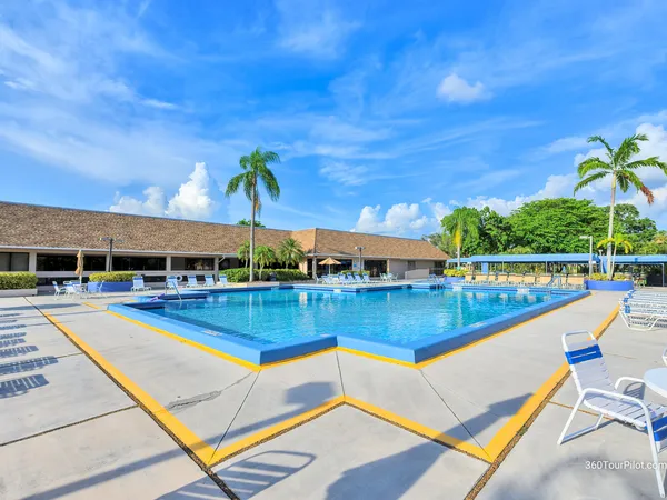 a view of a tennis court with sitting area