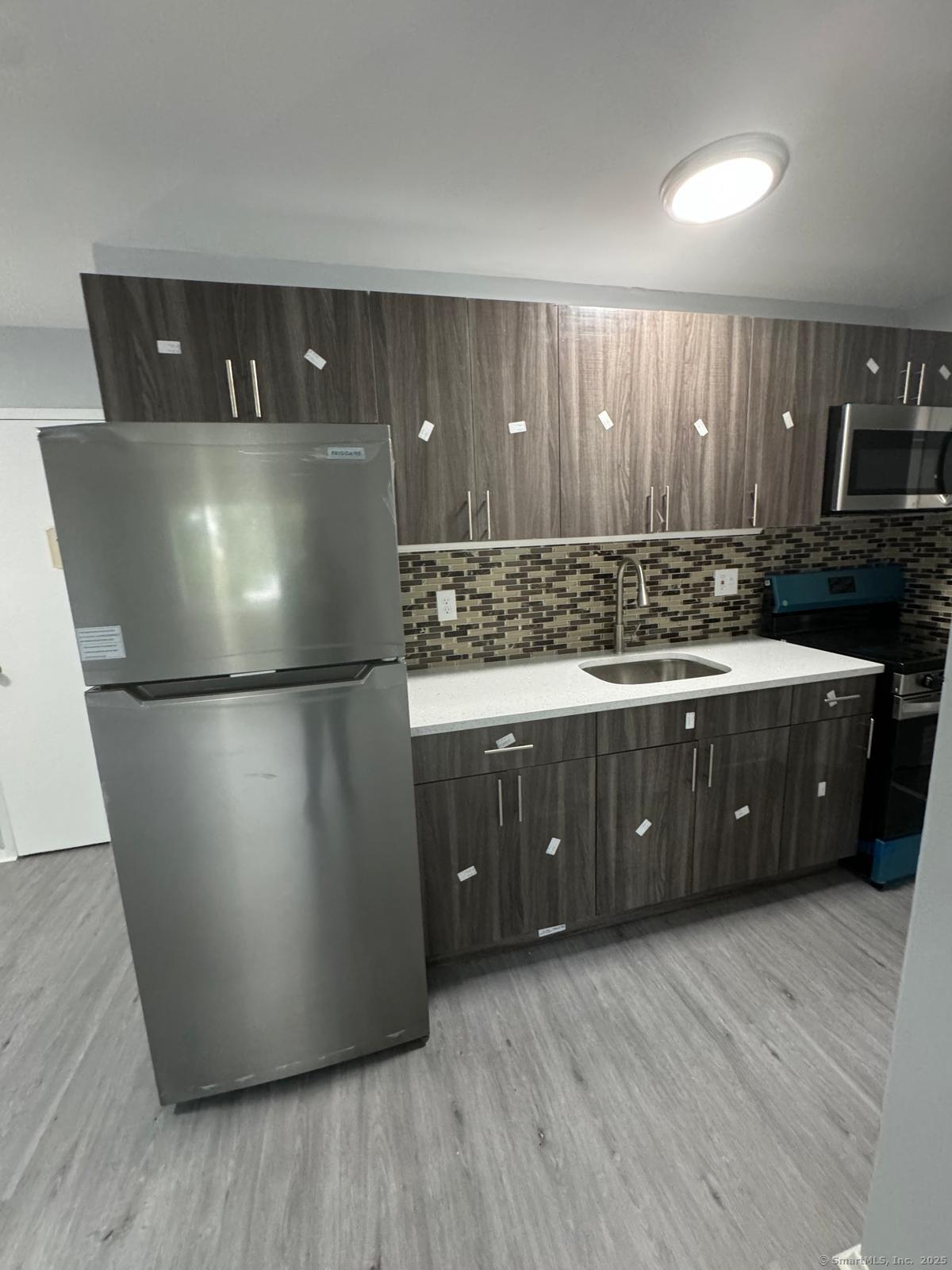 a kitchen with a refrigerator and a sink