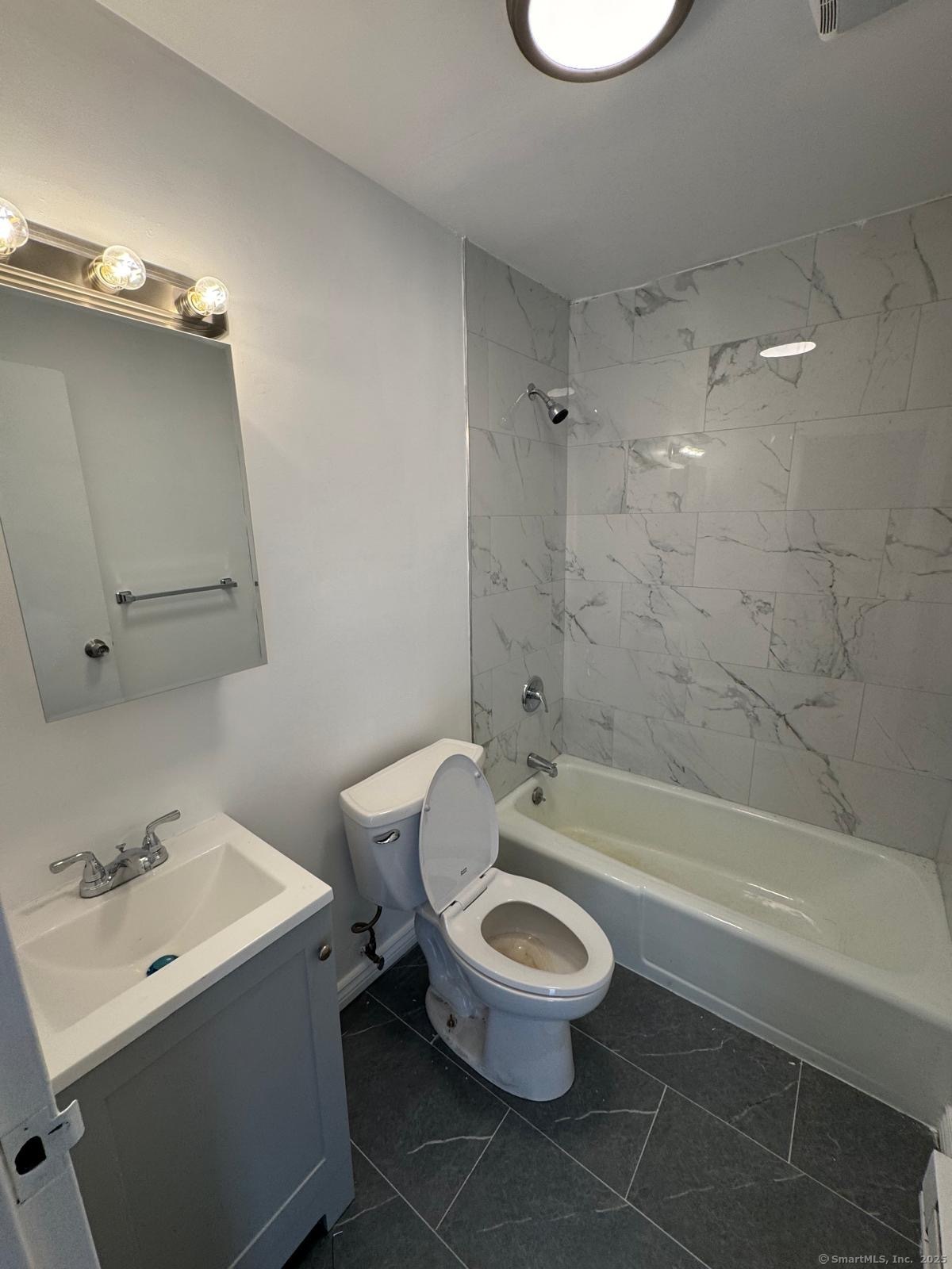 25 St Stephen Street, Unit C2 Bridgeport, CT 06610 - Photo 3 of 3 a bathroom with a sink a toilet and a bathtub