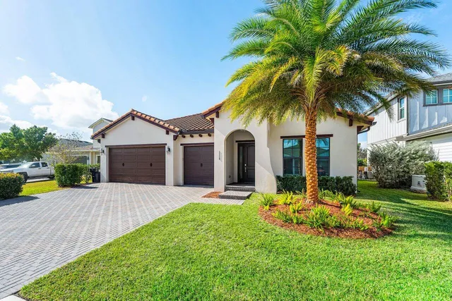 a view of a hallway with wooden floor and a bathroom