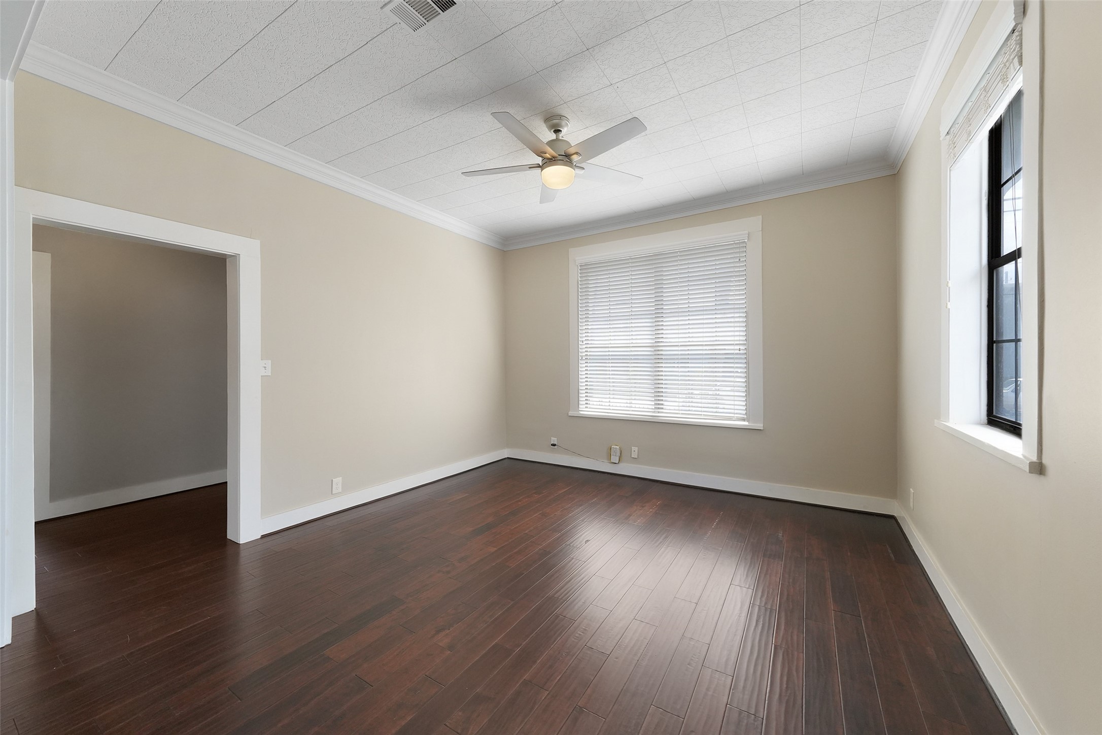 309 Pecore Street Houston, TX 77009 - Photo 12 of 45 a view of an empty room with wooden floor and a window