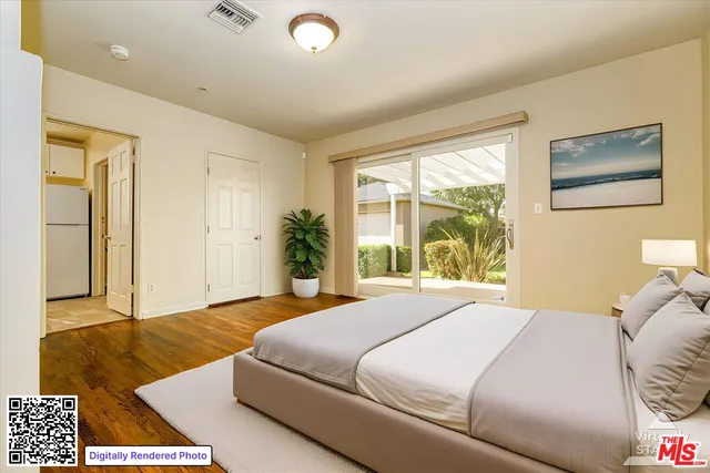 a bedroom with a bed and a large window