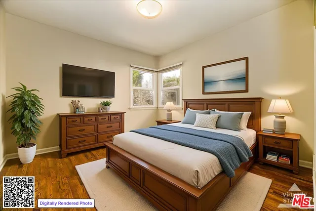 a bedroom with a bed and a flat screen tv