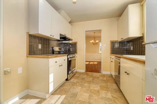 a kitchen with stainless steel appliances a sink and cabinets