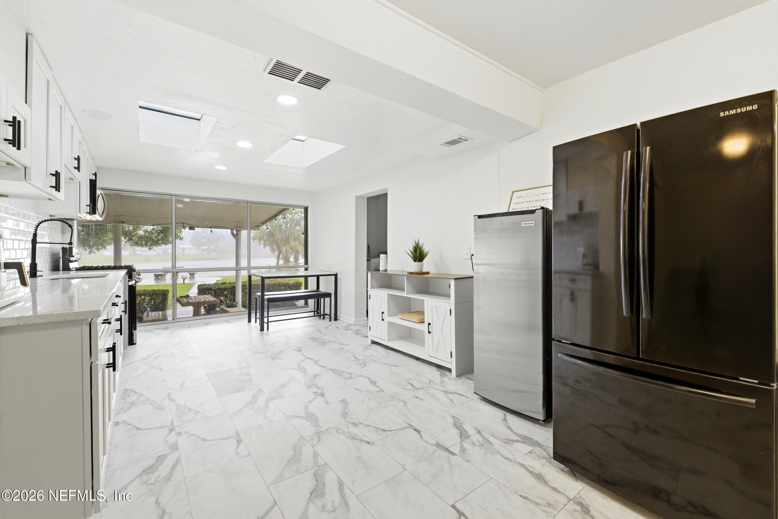 7484 Spinola Road Jacksonville, FL 32217 - Photo 18 of 63 a kitchen with stainless steel appliances a refrigerator and a sink