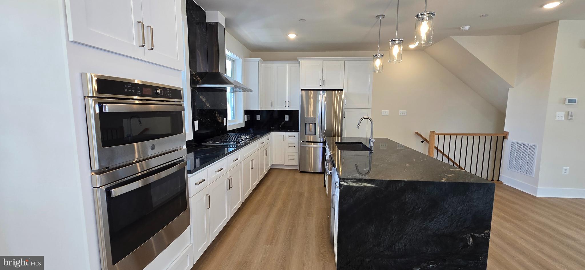 418 Chapel Alley, Unit 4 Frederick, MD 21701 - Photo 12 of 41 a kitchen with stainless steel appliances a stove a sink and a refrigerator