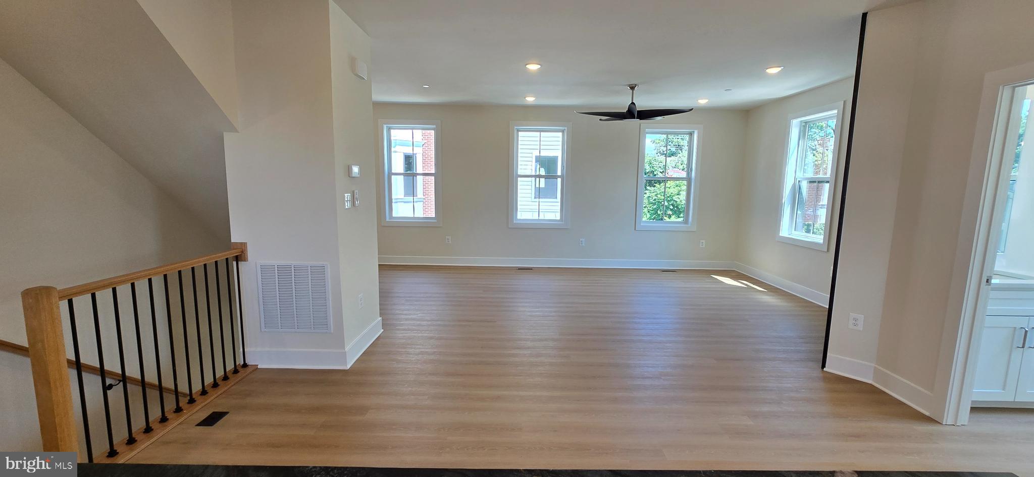 418 Chapel Alley, Unit 4 Frederick, MD 21701 - Photo 13 of 41 an empty room with wooden floor and windows