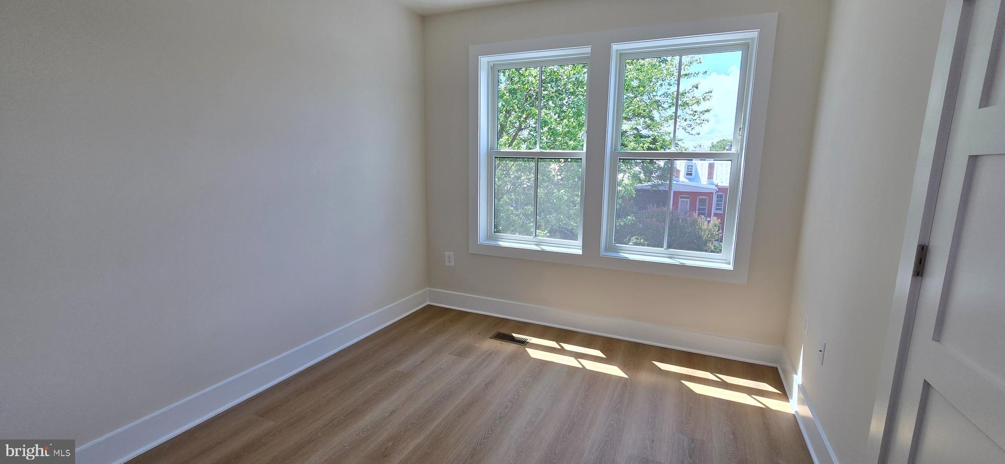 418 Chapel Alley, Unit 4 Frederick, MD 21701 - Photo 28 of 41 a view of an empty room with wooden floor and a window