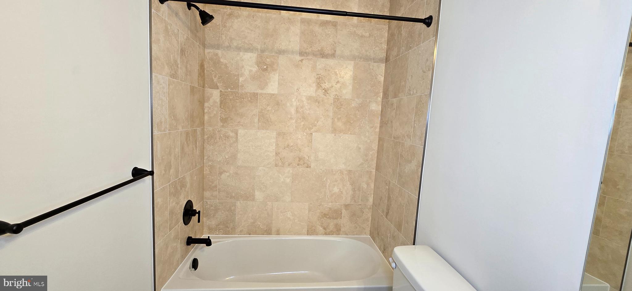 418 Chapel Alley, Unit 4 Frederick, MD 21701 - Photo 30 of 41 a bathroom with a shower and a bath tub