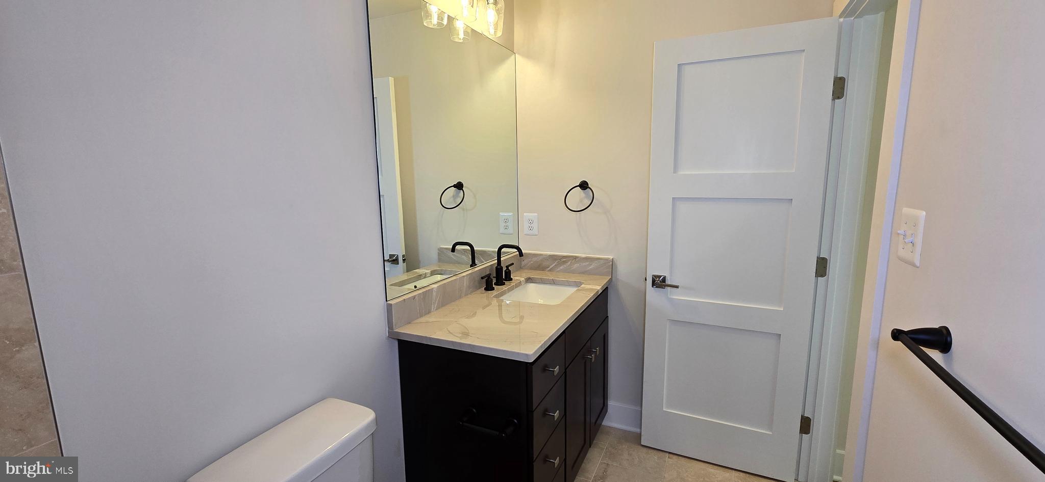 418 Chapel Alley, Unit 4 Frederick, MD 21701 - Photo 31 of 41 a bathroom with a sink toilet and vanity