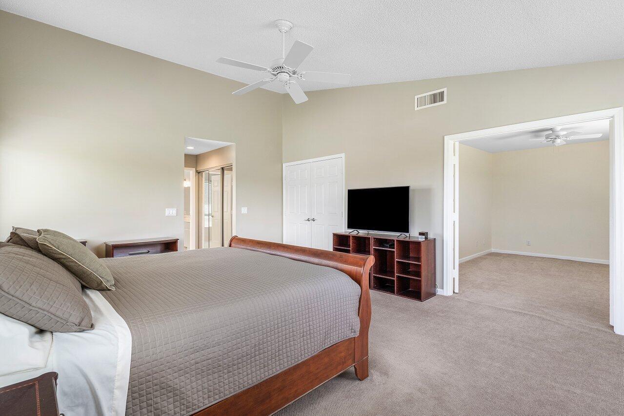 11842 Island Lakes Lane Boca Raton, FL 33498 - Photo 37 of 49 a bedroom with a bed and a flat screen tv