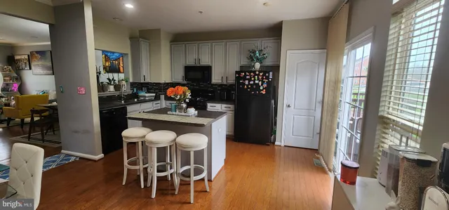 a kitchen with stainless steel appliances a refrigerator and a table