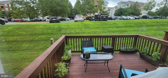 a view of a chair and table in backyard of the house