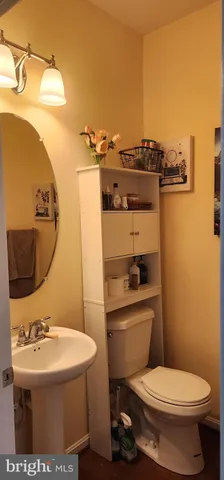 a bathroom with a sink toilet and mirror