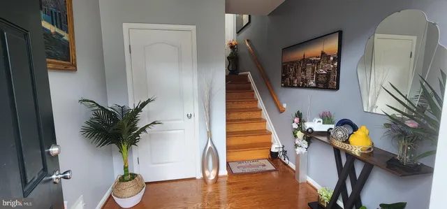 a view of entryway and hall with wooden floor