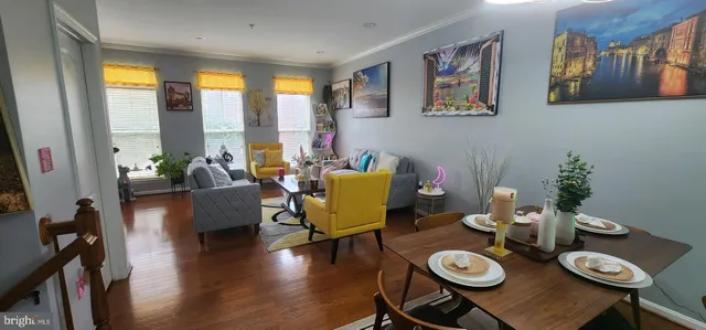 a living room with furniture and floor to ceiling windows