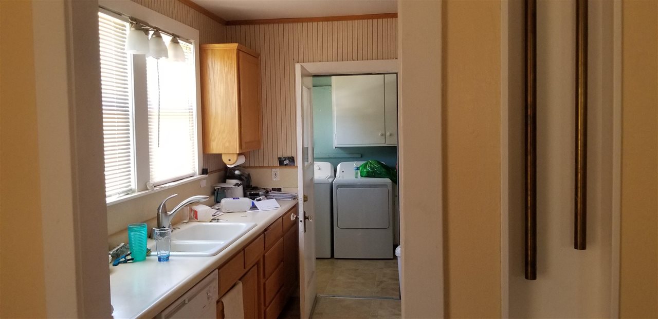 381 Aleut Street Biggs, CA 95917 - Photo 18 of 35 a bathroom with a granite countertop sink a toilet and a mirror