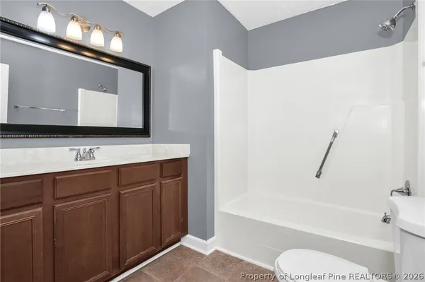 a bathroom with a sink a toilet and bathtub