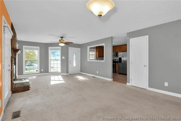 a view of livingroom with hardwood floor and a ceiling fan