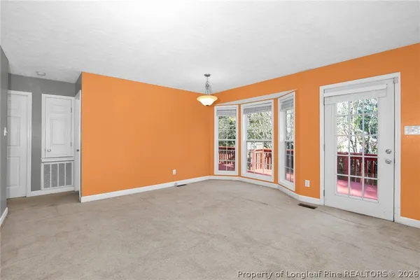 a view of an empty room with glass door