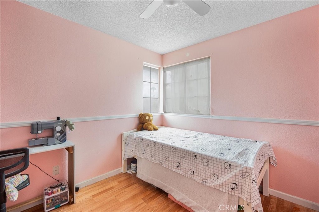 507 Coudures Way Perris, CA 92571 - Photo 24 of 41 a bedroom with a bed and a dresser in it