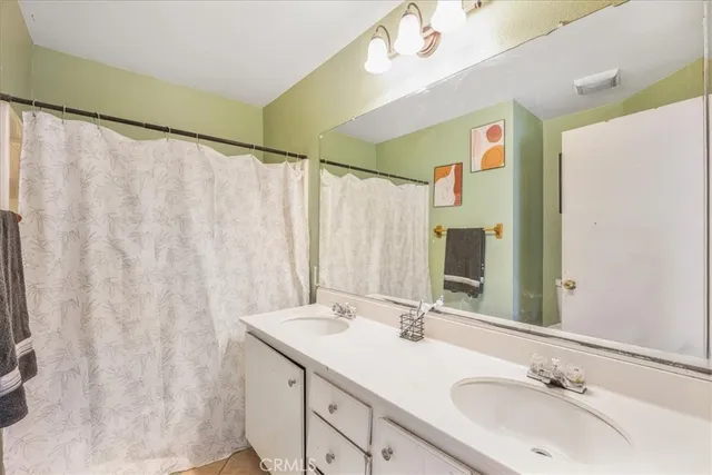a bathroom with a double vanity sink and a mirror