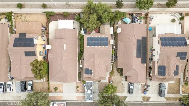 a aerial view of a house with a yard and potted plants