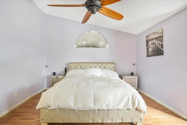 a large bed sitting in a bedroom next to a window