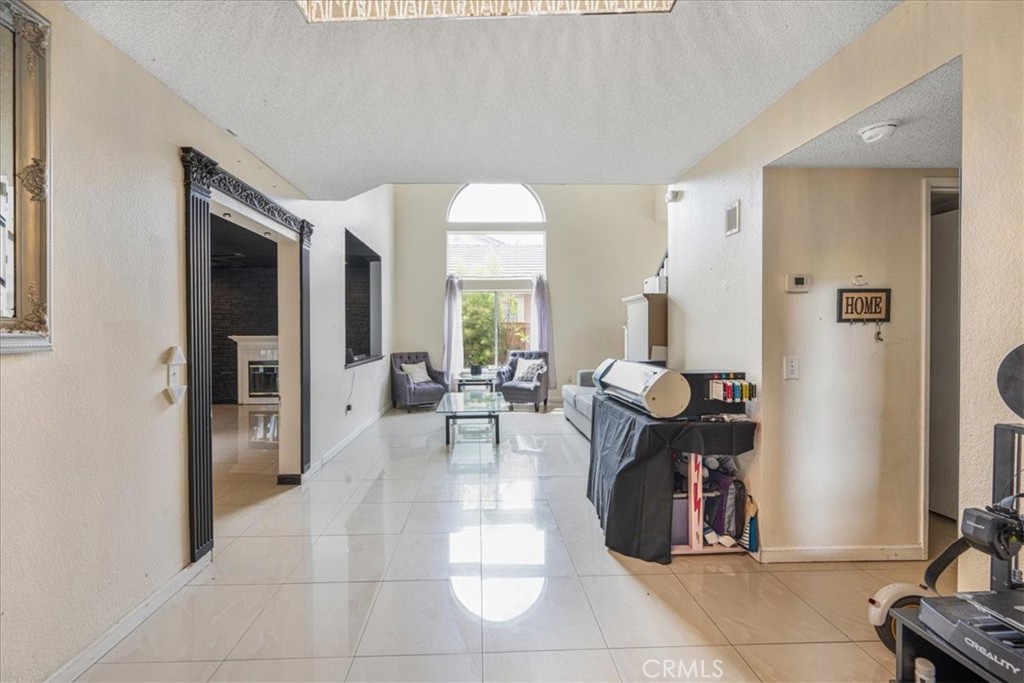 507 Coudures Way Perris, CA 92571 - Photo 35 of 41 a living room with furniture a dining table and a fireplace