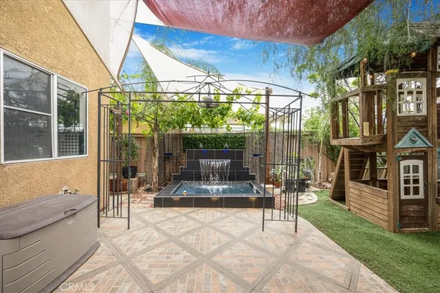 a view of a patio with a table and chairs