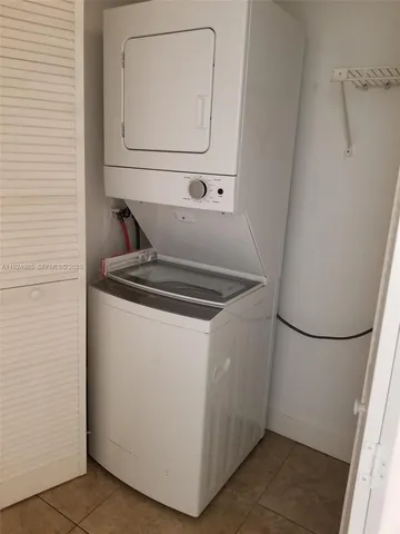 a utility room with wooden floor washer and dryer