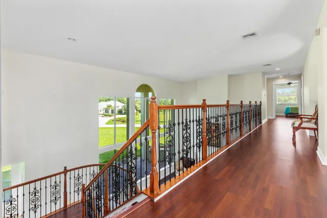 a view of entryway and hall with wooden floor