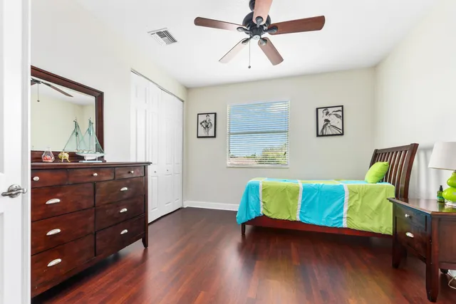 a room with a bed and wooden floor