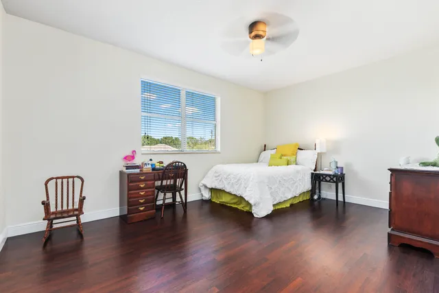a bedroom with furniture and a wooden floor